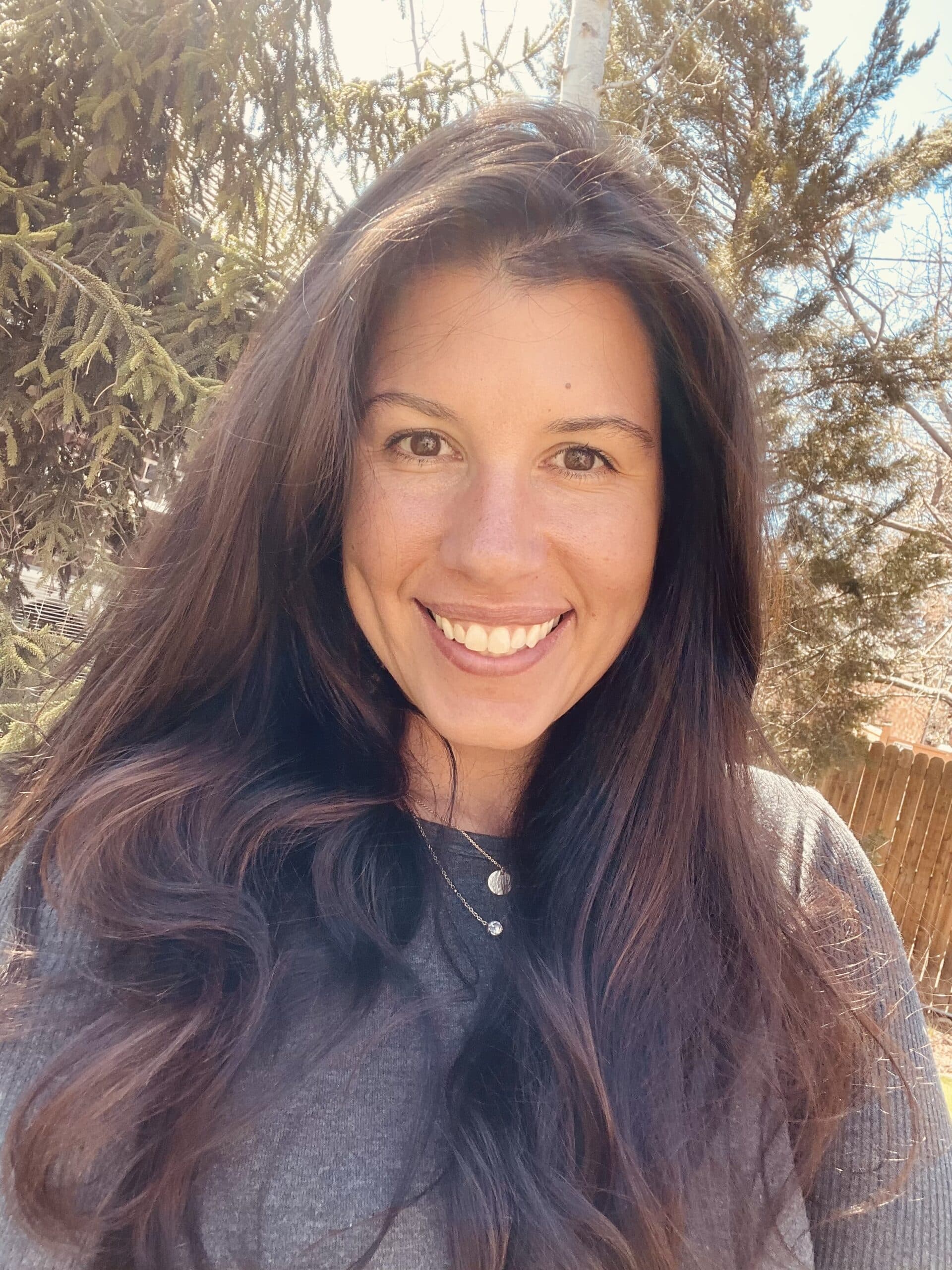 Erica Henston PMHNP with long hair outdoors.